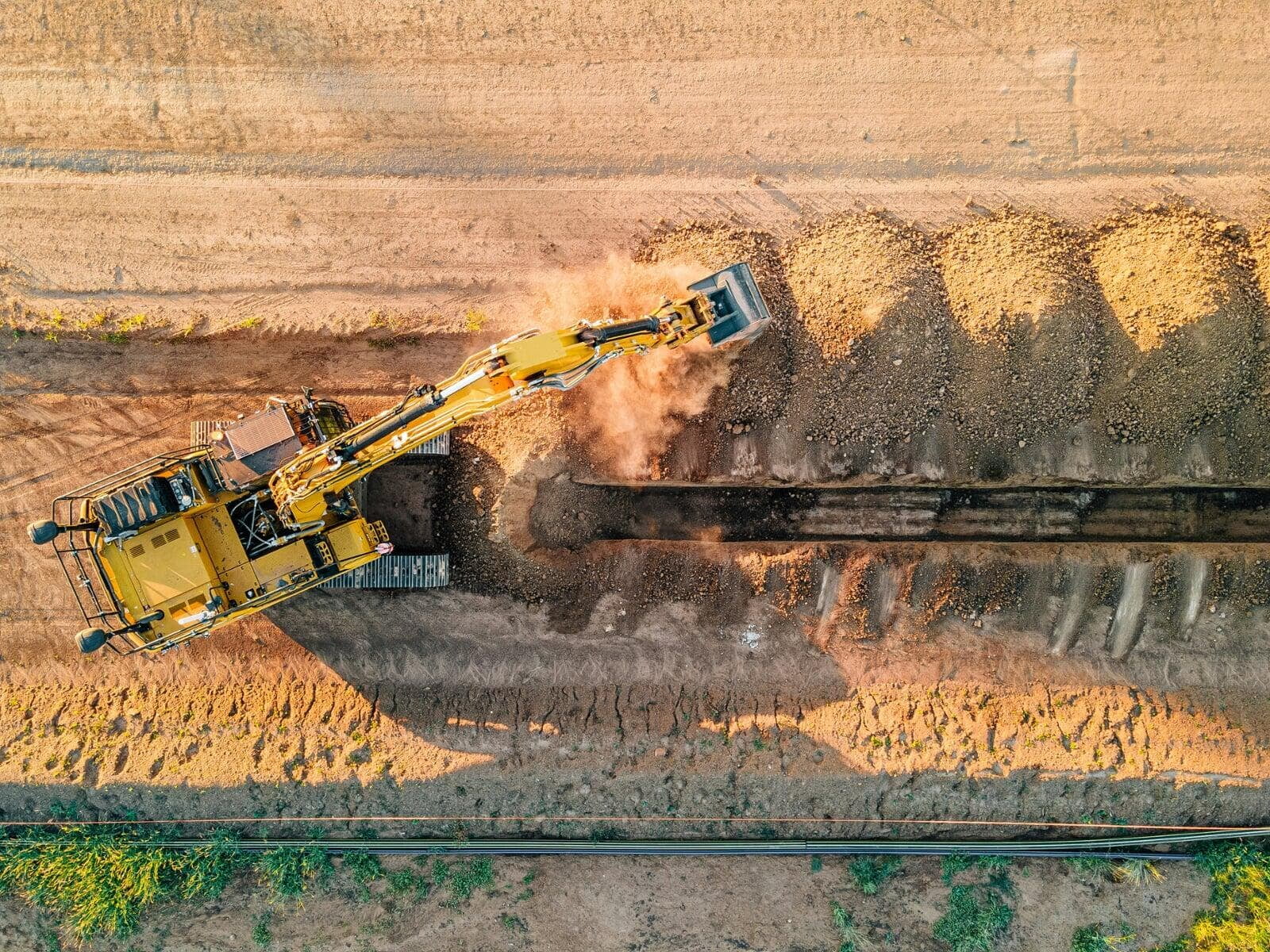 Aerial top down photo of a yellow excavator